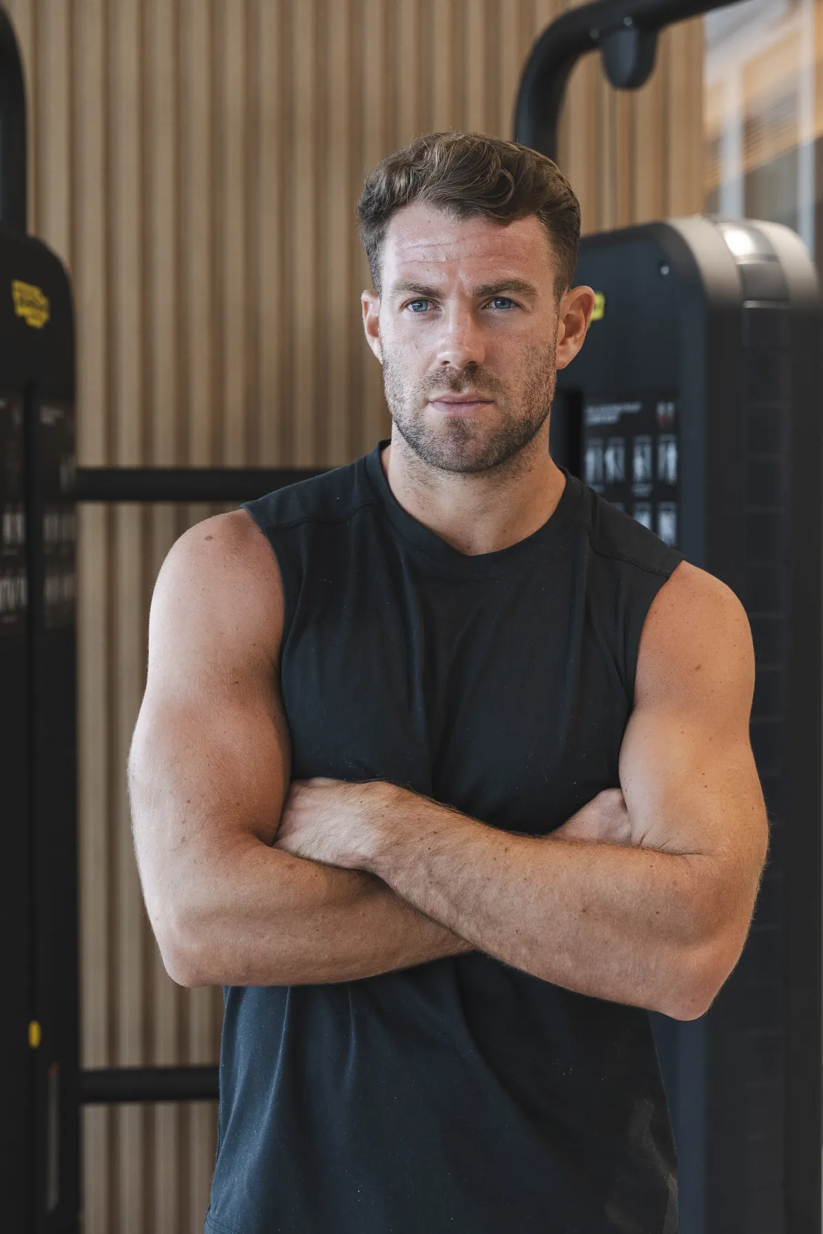 Bradley Simmonds in the gym with his arms crossed